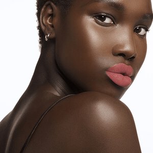 Model wearing soft pink lipstick.