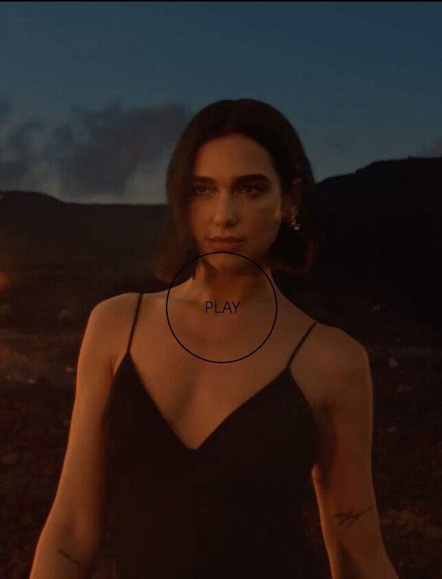 A woman in a black dress stands confidently against a dramatic landscape, with molten lava flowing in the background under a twilight sky.