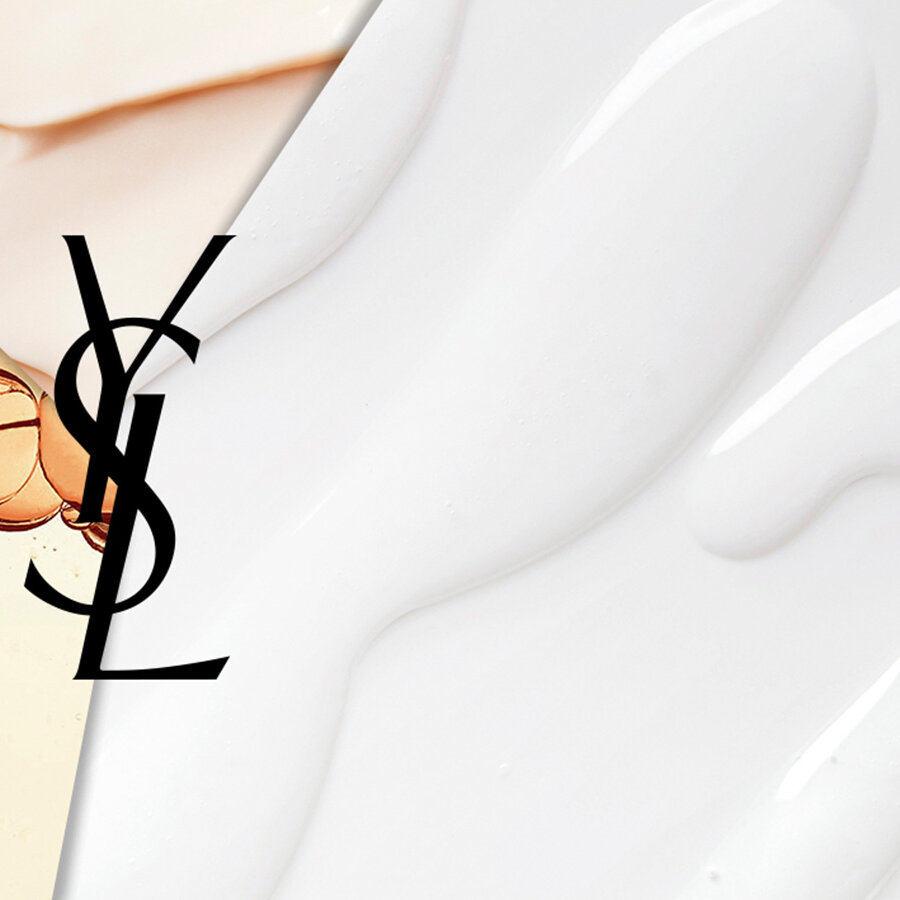 Abstract image featuring a split design with three textures: a peach liquid with bubbles, a creamy white substance, and a smooth surface. The iconic YSL logo is centered within the composition.