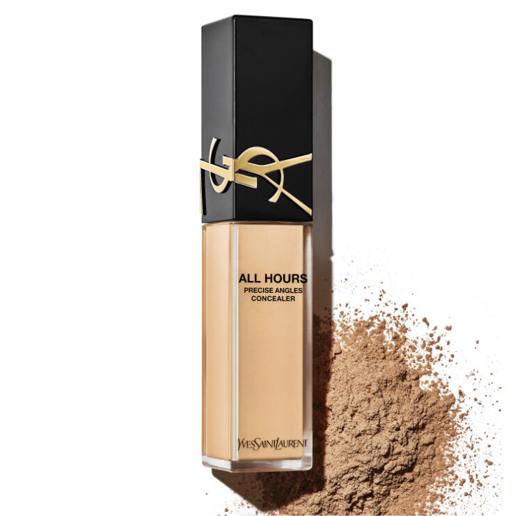 A bottle of Yves Saint Laurent All Hours Precise Angled Concealer, featuring a sleek black cap and transparent body with a golden logo, beside a pile of loose powder.