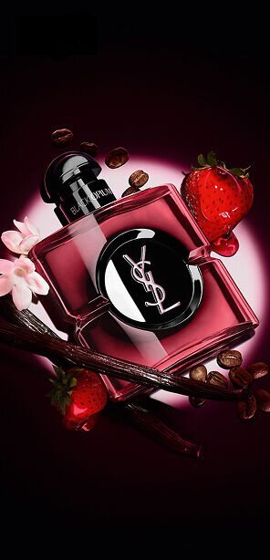 Black Opium Eau de Parfum Pink Glaze bottle surrounded by fresh strawberries, vanilla pods, coffee beans, and jasmine.