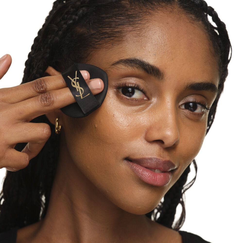 Gros plan montrant comment utiliser le YSL SKIN AFFAIR CUSHION sur la joue pour une couvrance homogène, modulable et lumineuse.